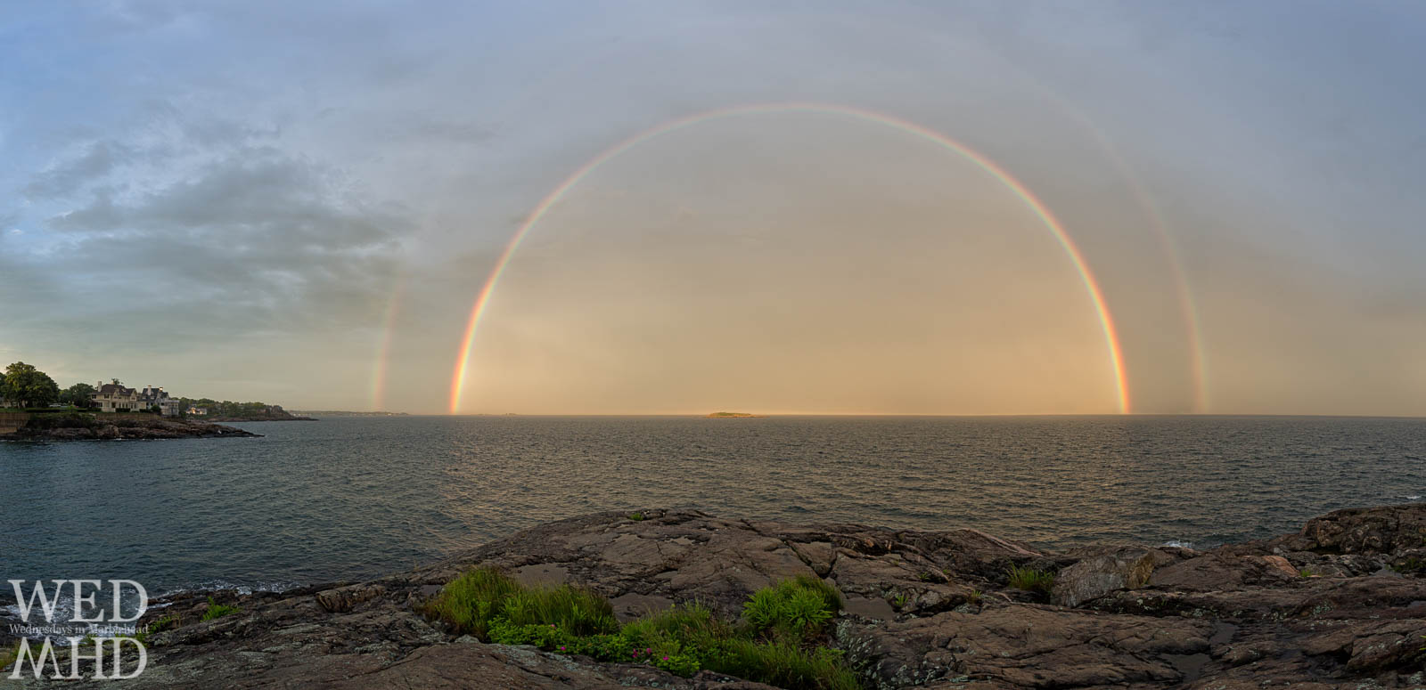 full double rainbow over water