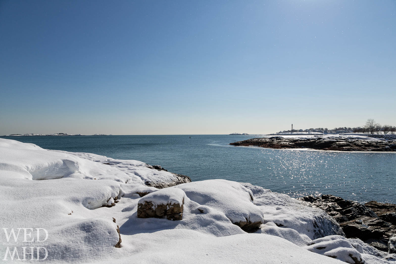 Virgin snow covers Brown's Island with a view towards Marblehead Light