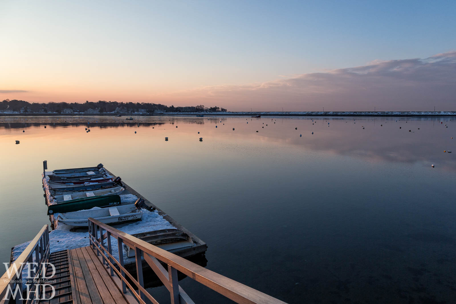 Boats surrounded by snow on the float off Hammond Park at dawn
