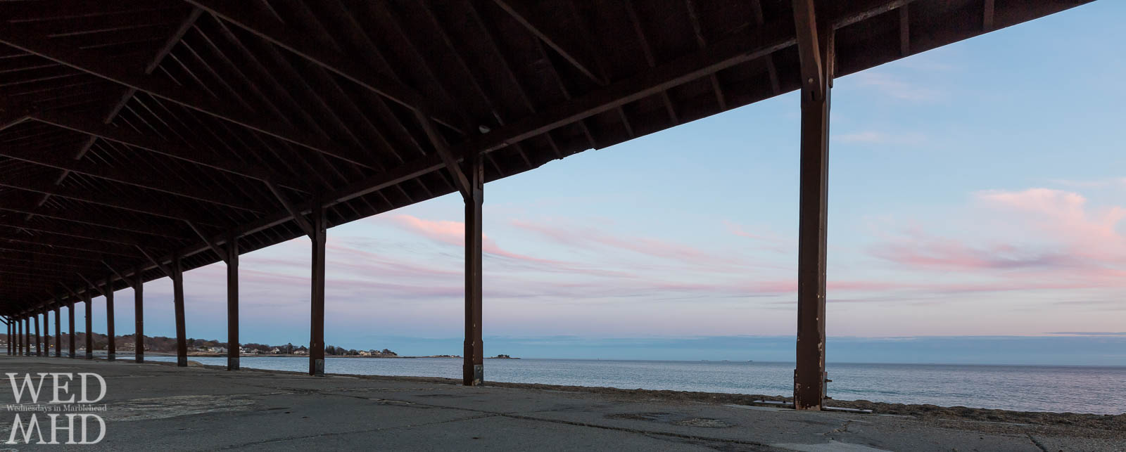 A Spring sunset is framed by the gazebo at Devereux Beach