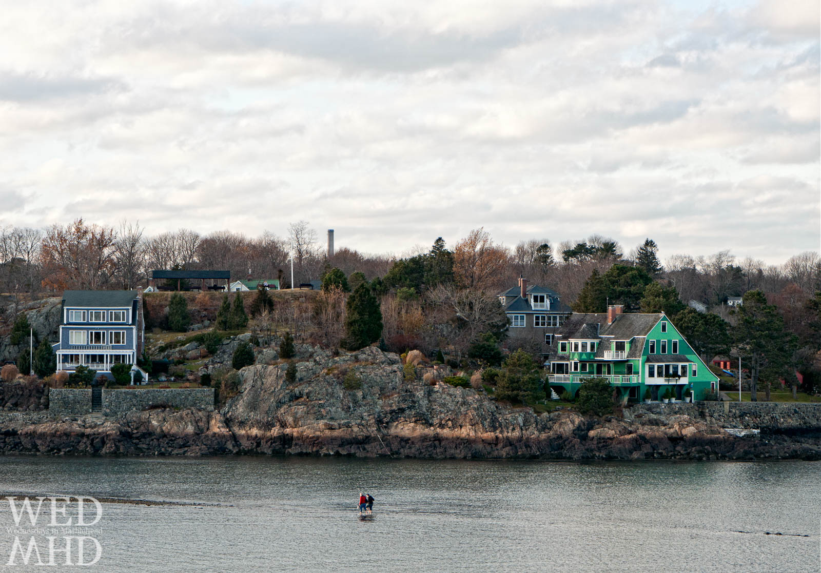 Two people seen walking on water as the land bridge disappears in Little Harbor