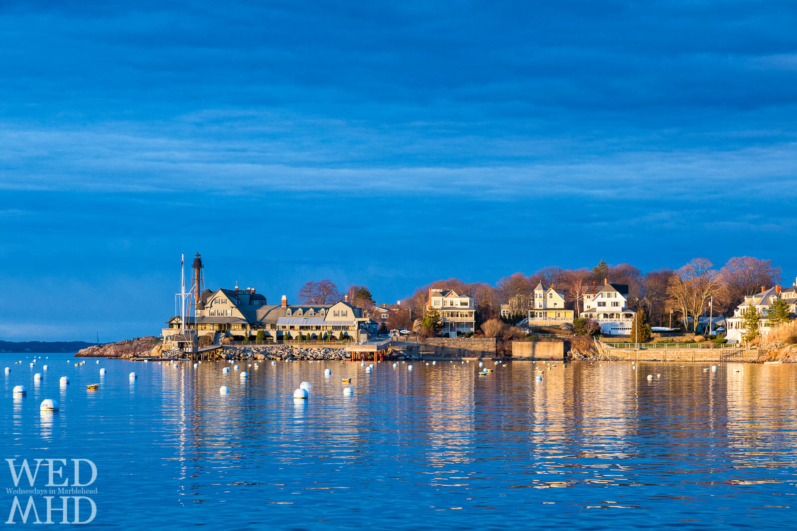 Golden light bathes Marblehead Neck and an empty Marblehead harbor in late April