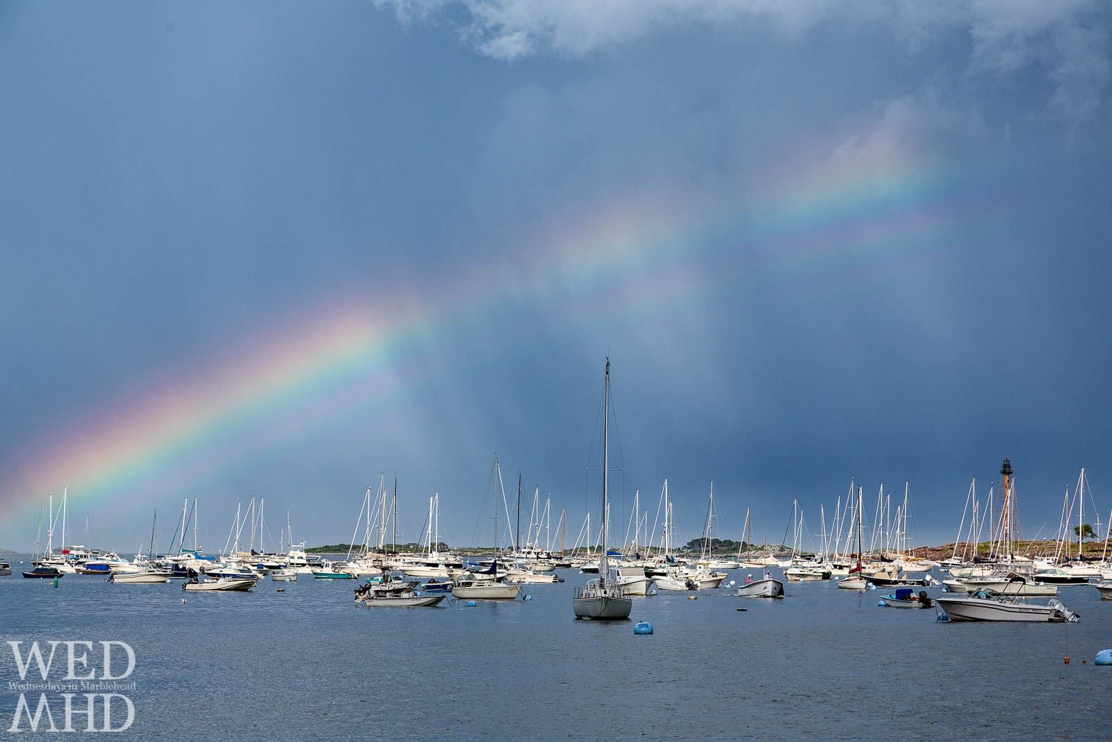 Marblehead Light at the end of the rainbow with boats filling the foreground