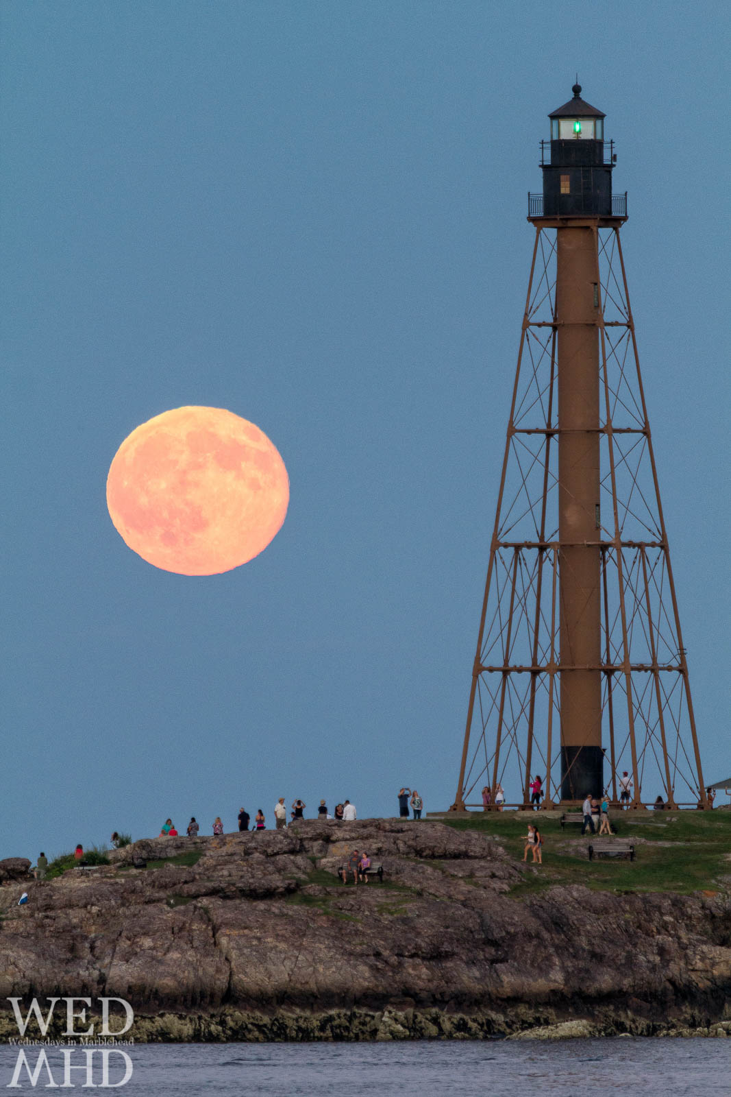 A rare blue moon rises over Chandler Hovey Park where people gather to watch it rise