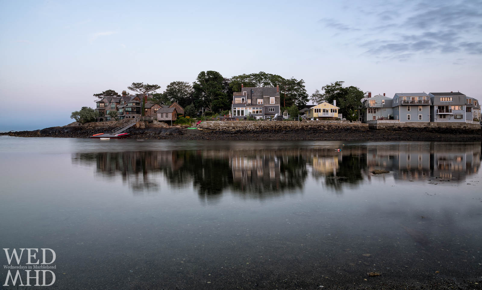 Houses along Fort Sewall Lane reflec in the still waters of Little Harbor