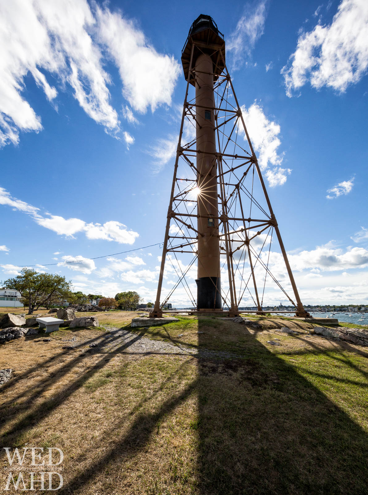 A sunstar forms along Marblehead Light on a perfect Summer day.  The Canon 11-24mm lens produces a beautiful 18-point sunstar.