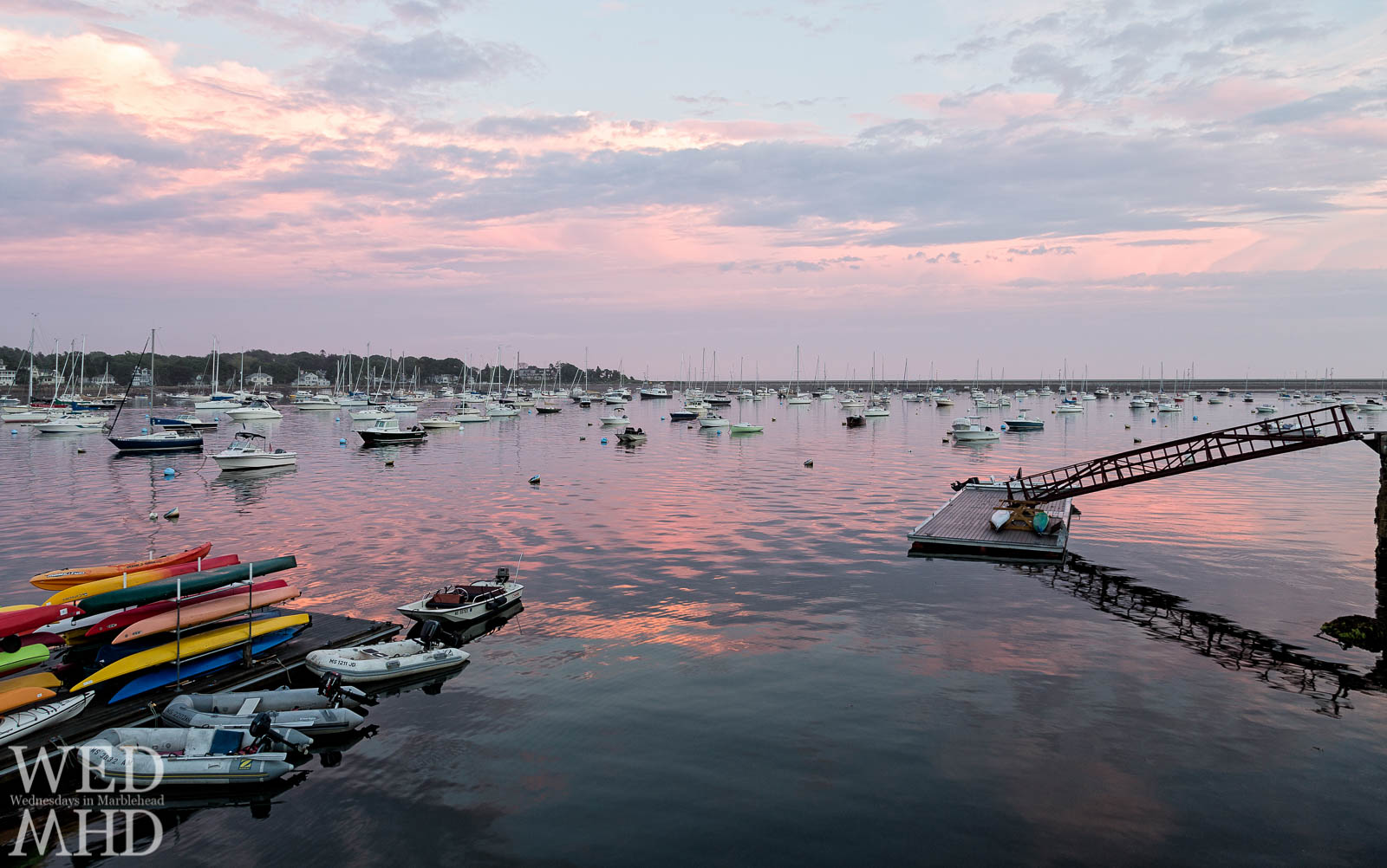 Kayaks add color to this pink sunset over Marblehead Harbor captured on a late Spring day