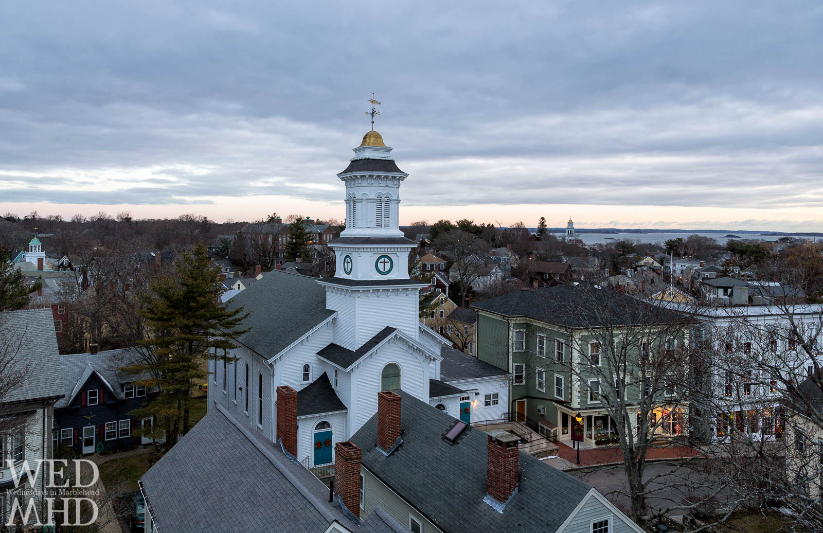 A view of Pleasant Street at dawn from atop St. Michael's steeple showcases Grace Community Church and stores in historic downtown Marblehead