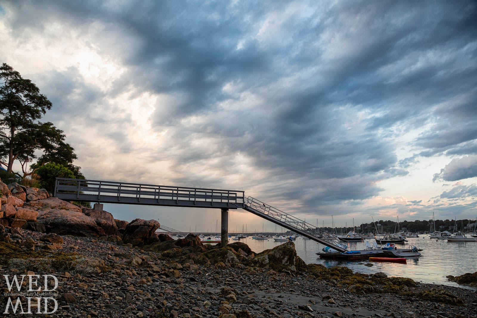 A dramatic sky encircles the pier at Parker Lane on a Summer evening in Marblehead