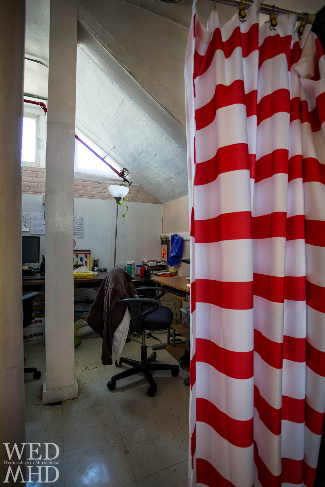 Two offices are seperated from the art room and basement gymnasium by a shower curtain at the Gerry School