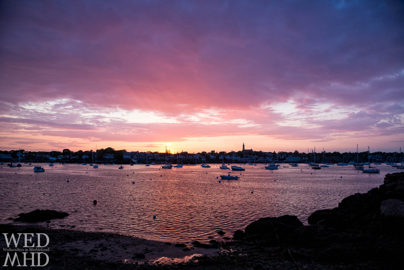 A perfect sunset is accompanied by a warm breeze as the first breath of Summer passes through Marblehead