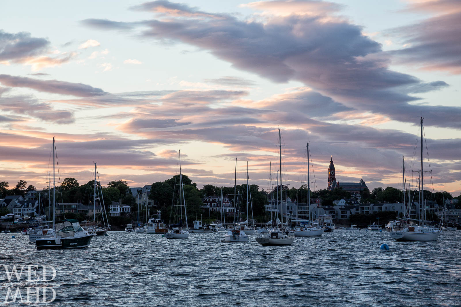 Golden light strikes Abbot hall at sunset in this view from Riverhead Beach in Marblehead