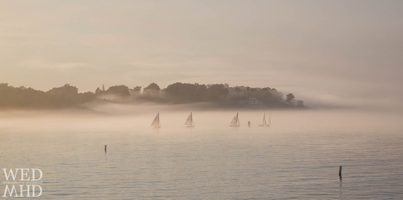 Mist envelopes Marblehead as these boats in the fog race out of the harbor