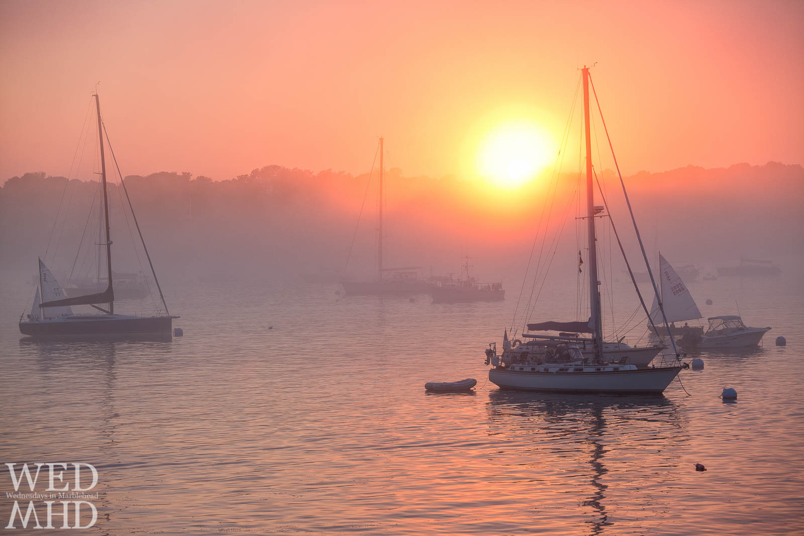 A brilliant light shines through this foggy sunset in Marblehead