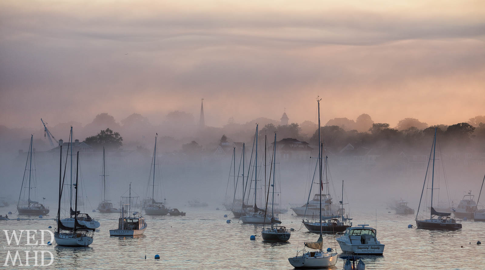 Marblehead's skyline is transformed by thick fog so that masts and steeples become the only familiar landmarks