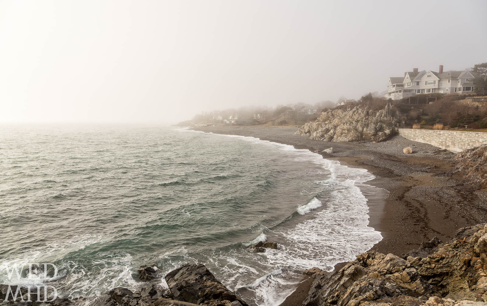 A view of the coastline in the fog along Marblehead Neck as seen from Castle Rock on a beautiful February morning. Perfect wave form formed along the beach.