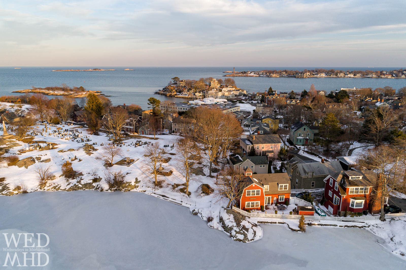 An aerial view of golden light on Redd's pond includes Old Burial Hill, Gerry Island, Fort Sewall and Marblehead Neck