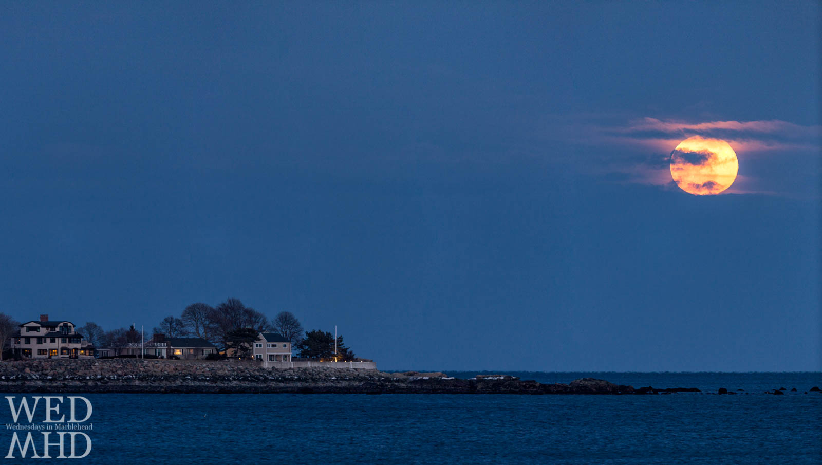 The full worm moon rises on a cold March evening over flying point on Marblehead Neck