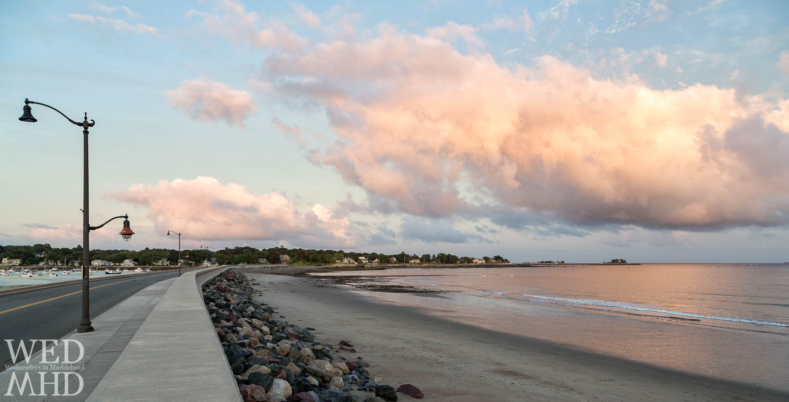 The causeway curves to meet the light of a September sunset reflecting off a cumulous cloud and the still waters below