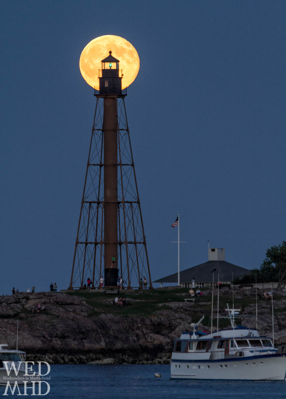 The moon rises behind Marblehead Light and is framed perfectly by the green beacon creating a moonrise symmetry on this July evening