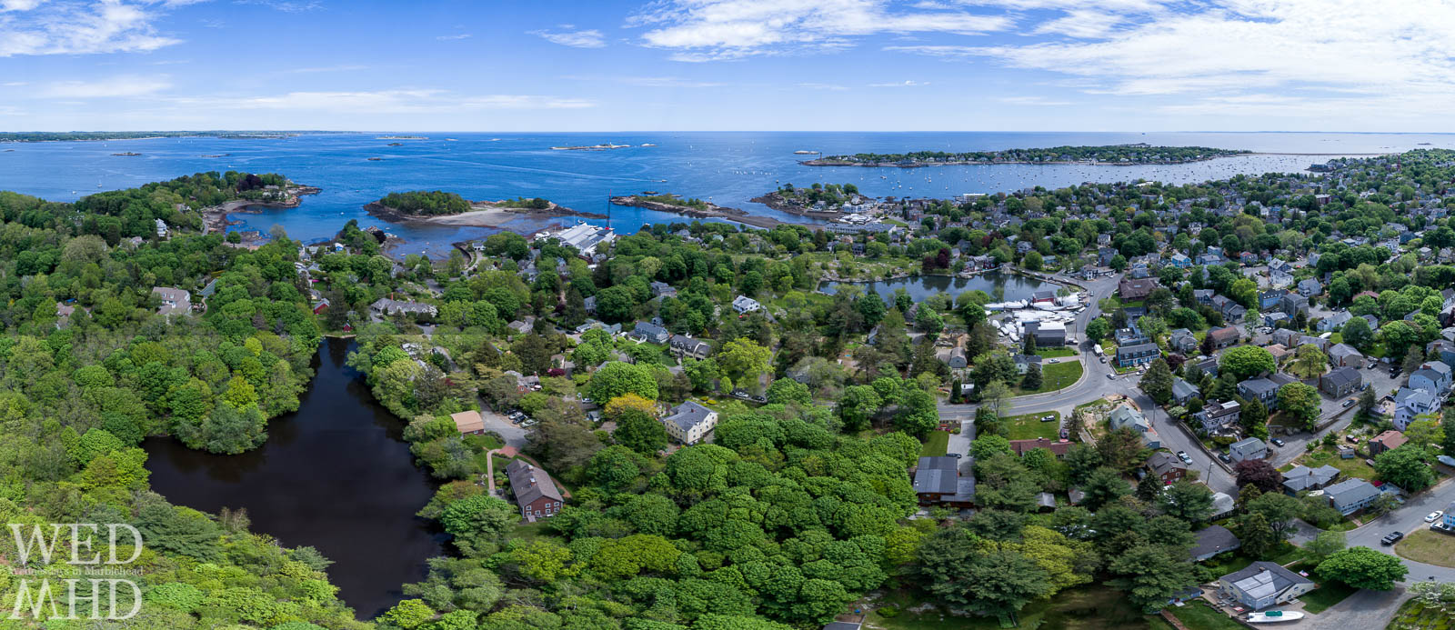 Black Joes Pond surrounded by foliage and Gingerbread Hill in the Barnegat section of Marblehead captured from overhead