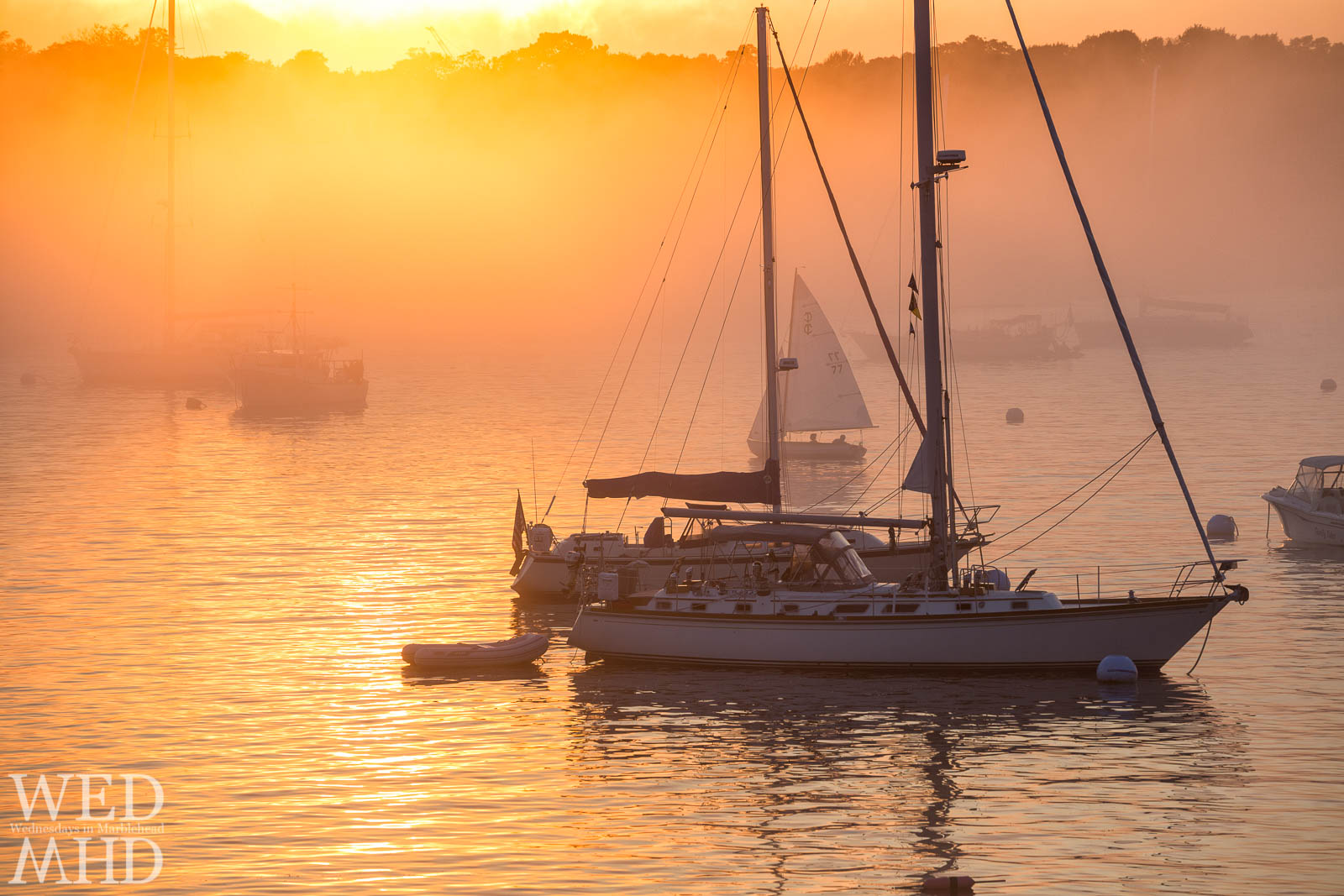 Summer fog takes hold of Marblehead Harbor at sunset on a warm Summer evening