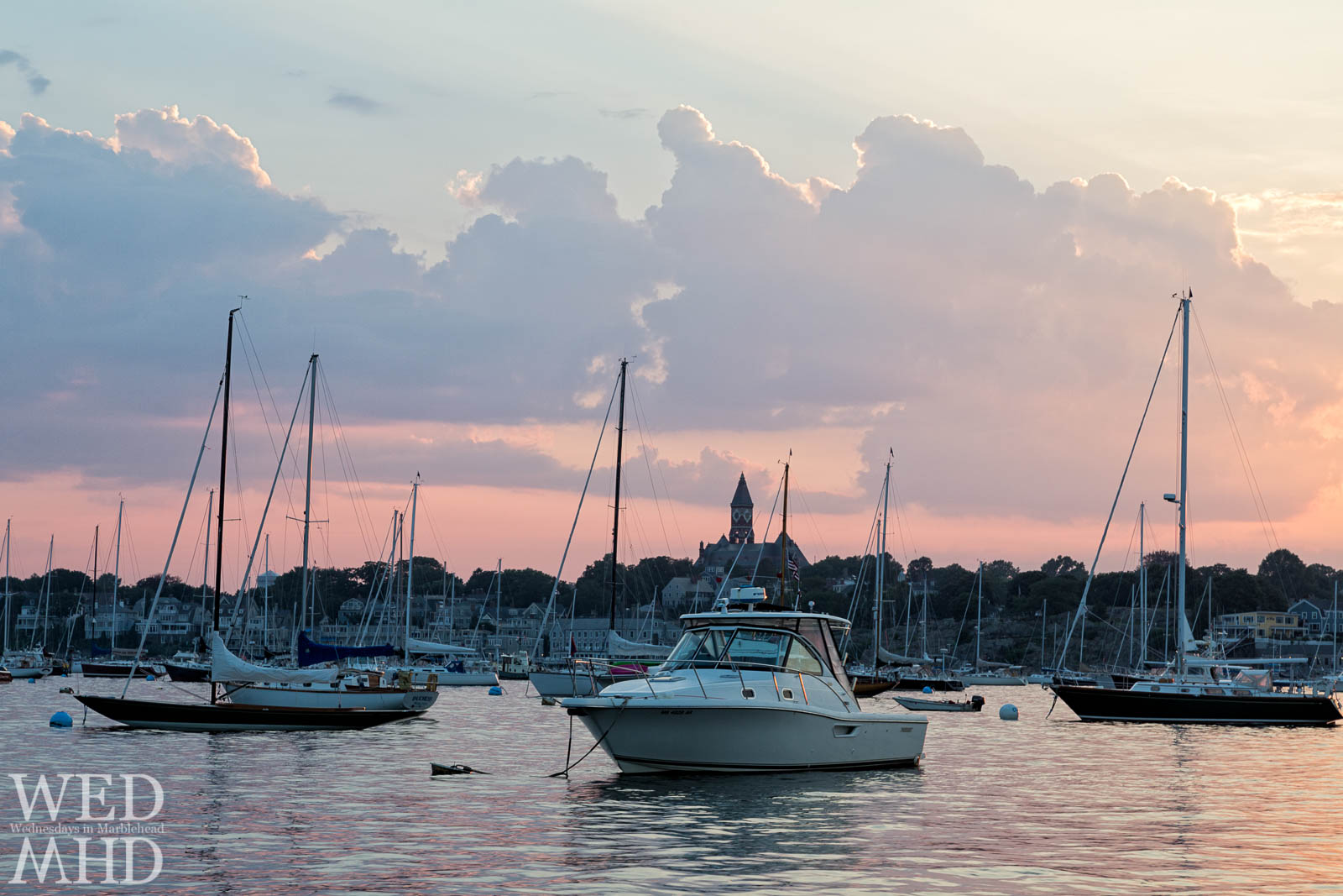 An impromptu harbor tour takes place on a mid-July evening with endless views of boats on their moorings and great light in the sky reflecting in the still waters