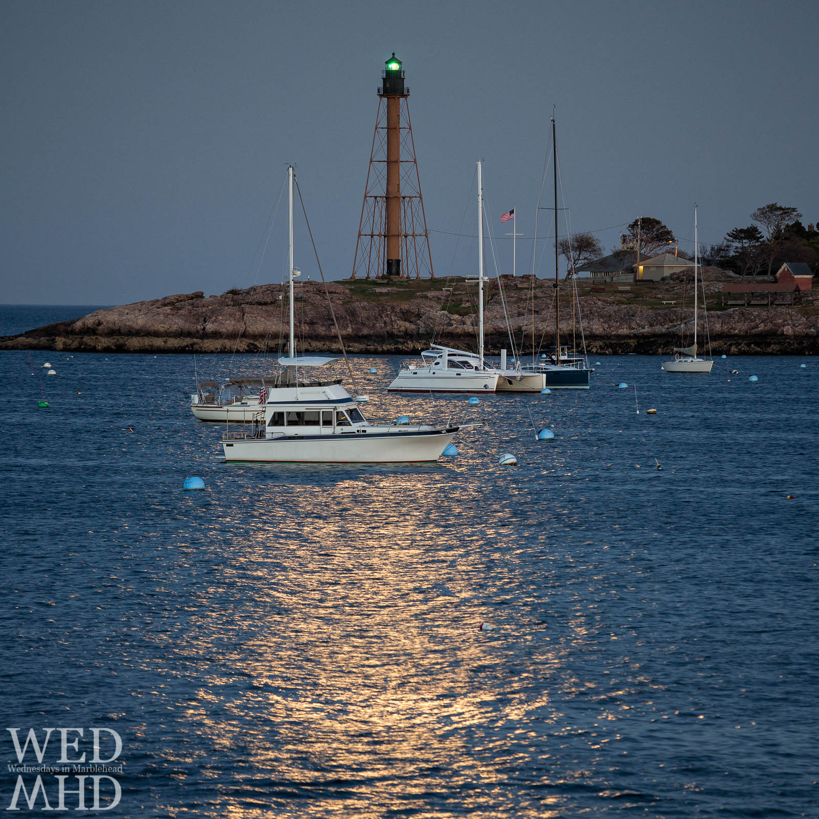Boats in Marblehead Harbor are moored by moonlight under the light of the Harvest Moon