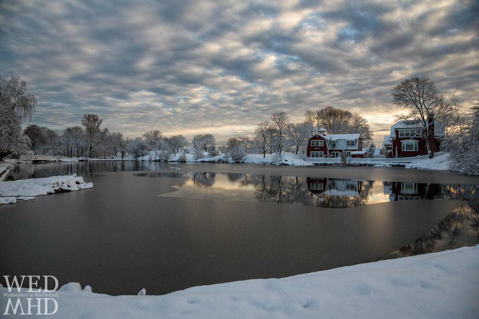 The sun rises over Redd's Pond which has begun to freeze after the first snowfall of the season