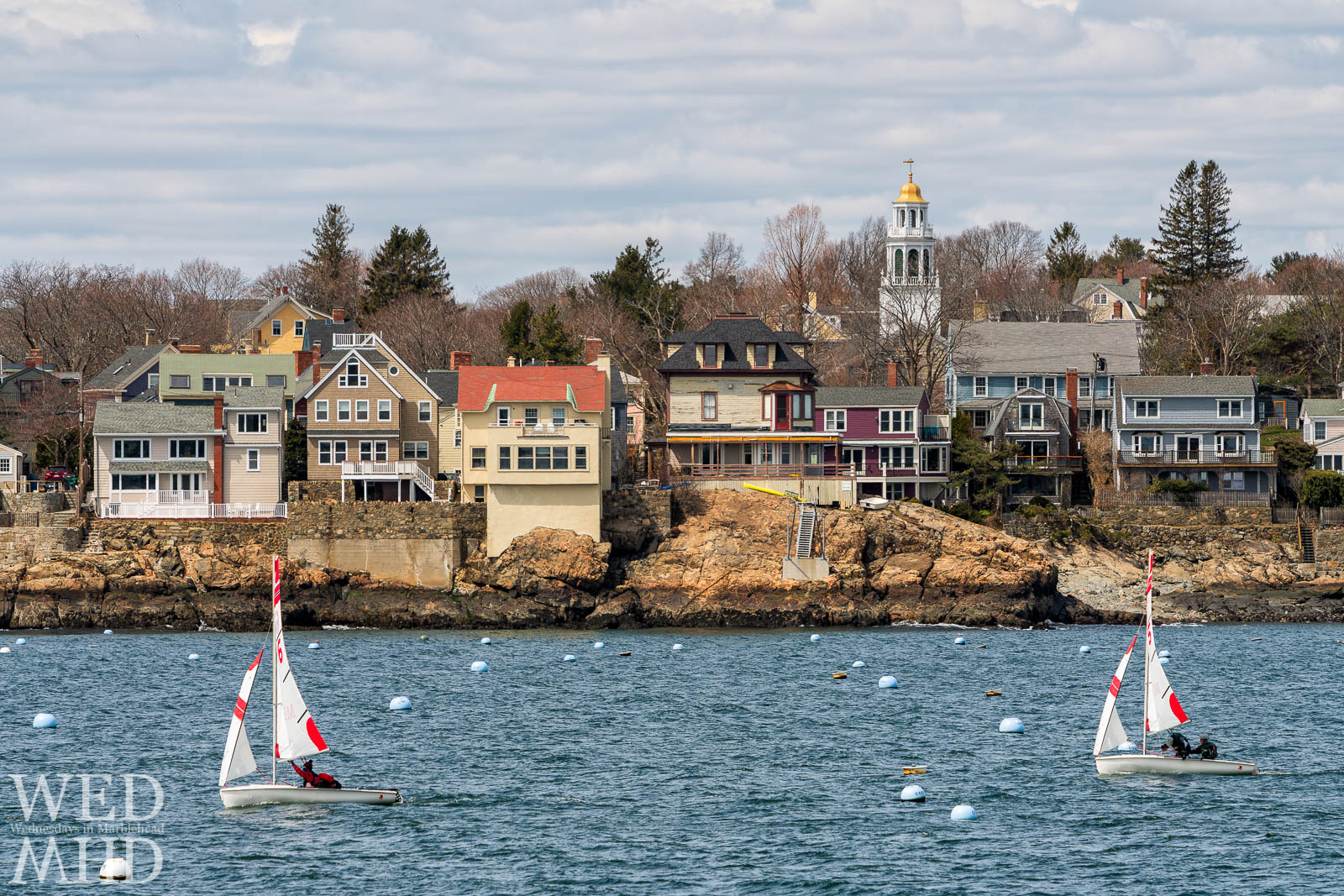 Frostbite sailing takes place each winter in Marblehead Harbor. Here two boats pass in front of the Old North Church