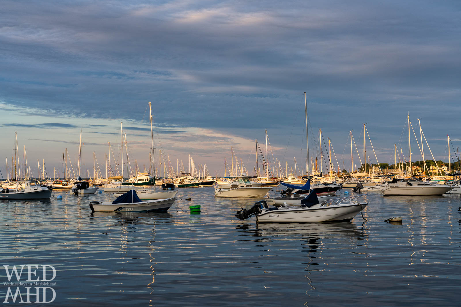 A boat named Dyaynu is nearly lost in the crowd of a full Marblehead harbor as seen on an early September evening