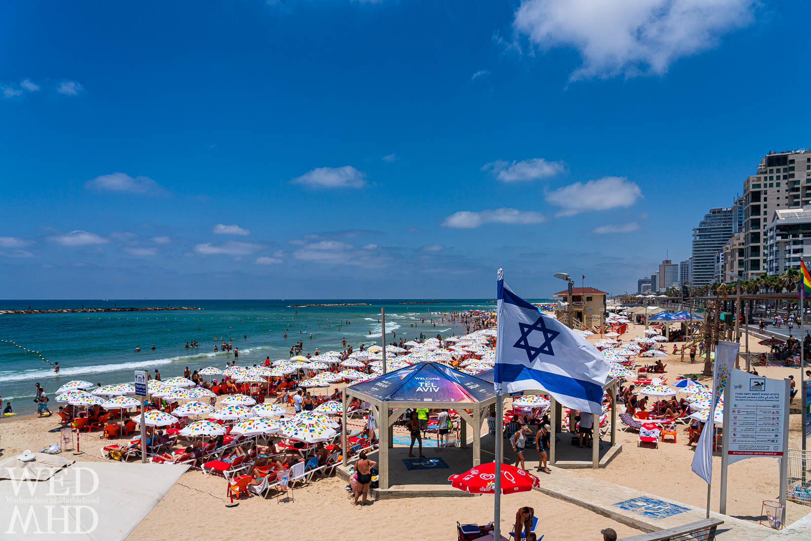 Israel's flag with the Magen David (Star of David) flies in the wind over Banana Beach in Tel Aviv