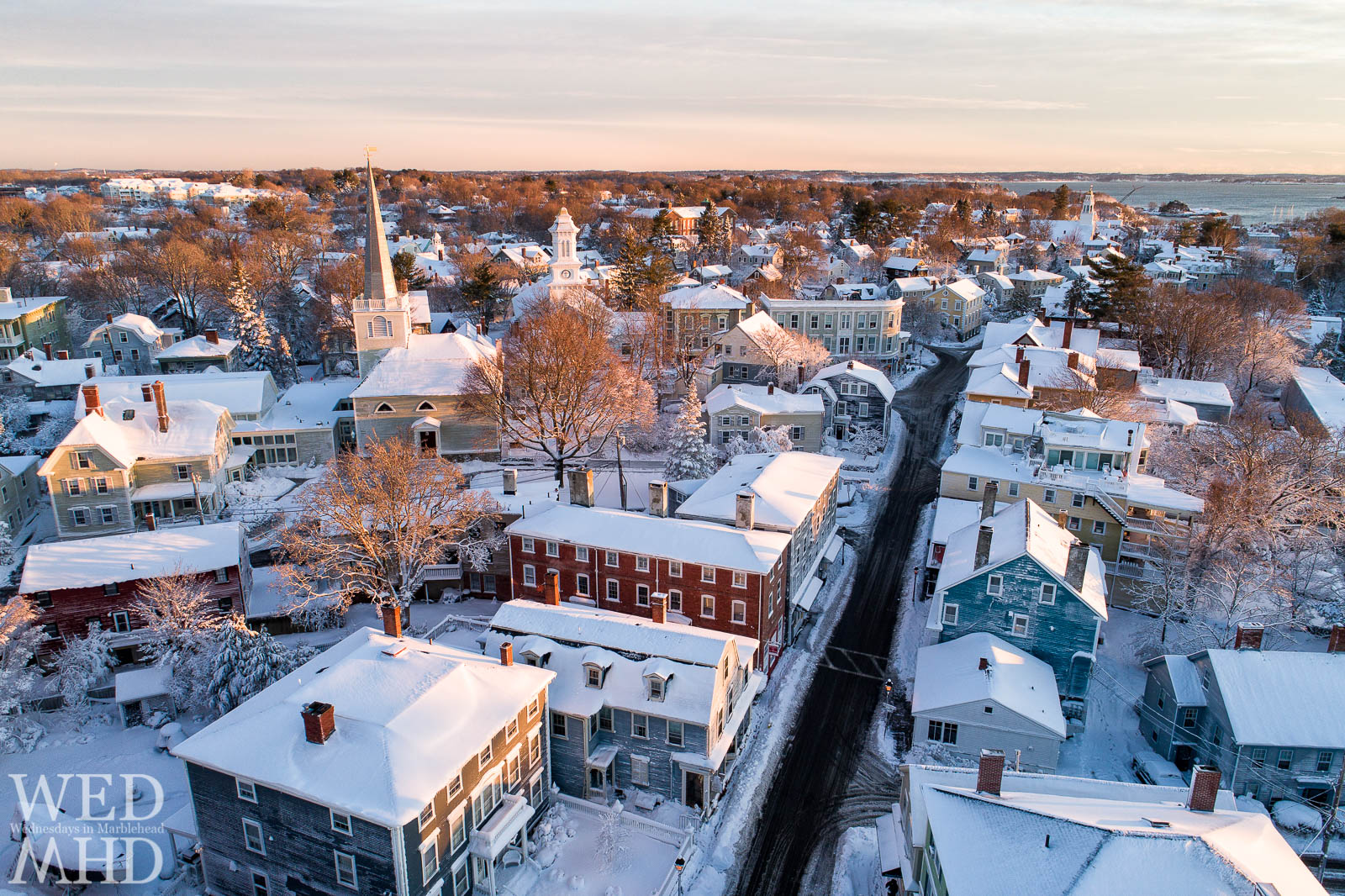 An aerial image of historic downtown Marblehead with a dusting of snow and early morning light