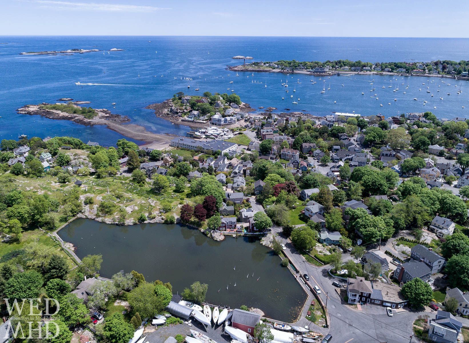 An aerial juxtaposition of big boats in Marblehead Harbor and little boats in Redd's Pond on a May afternoon