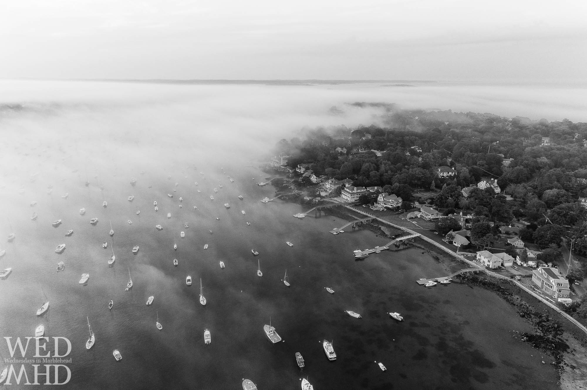The fog rolls in over Marblehead harbor and the neck in this aerial image captured on a mid July evening