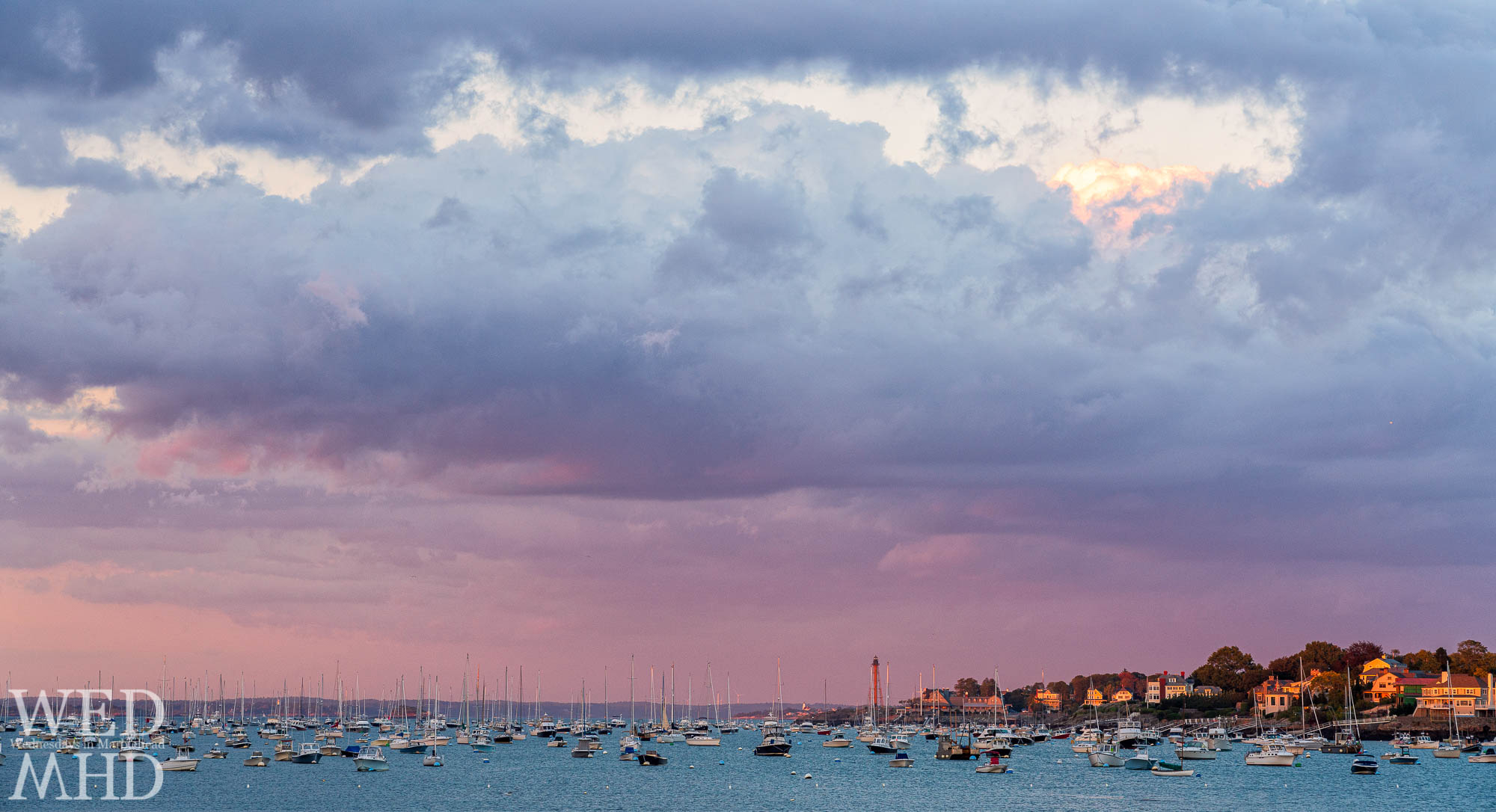 A pink-purple October sky takes shape over Marblehead Harbor as the sun sets on an early October evening