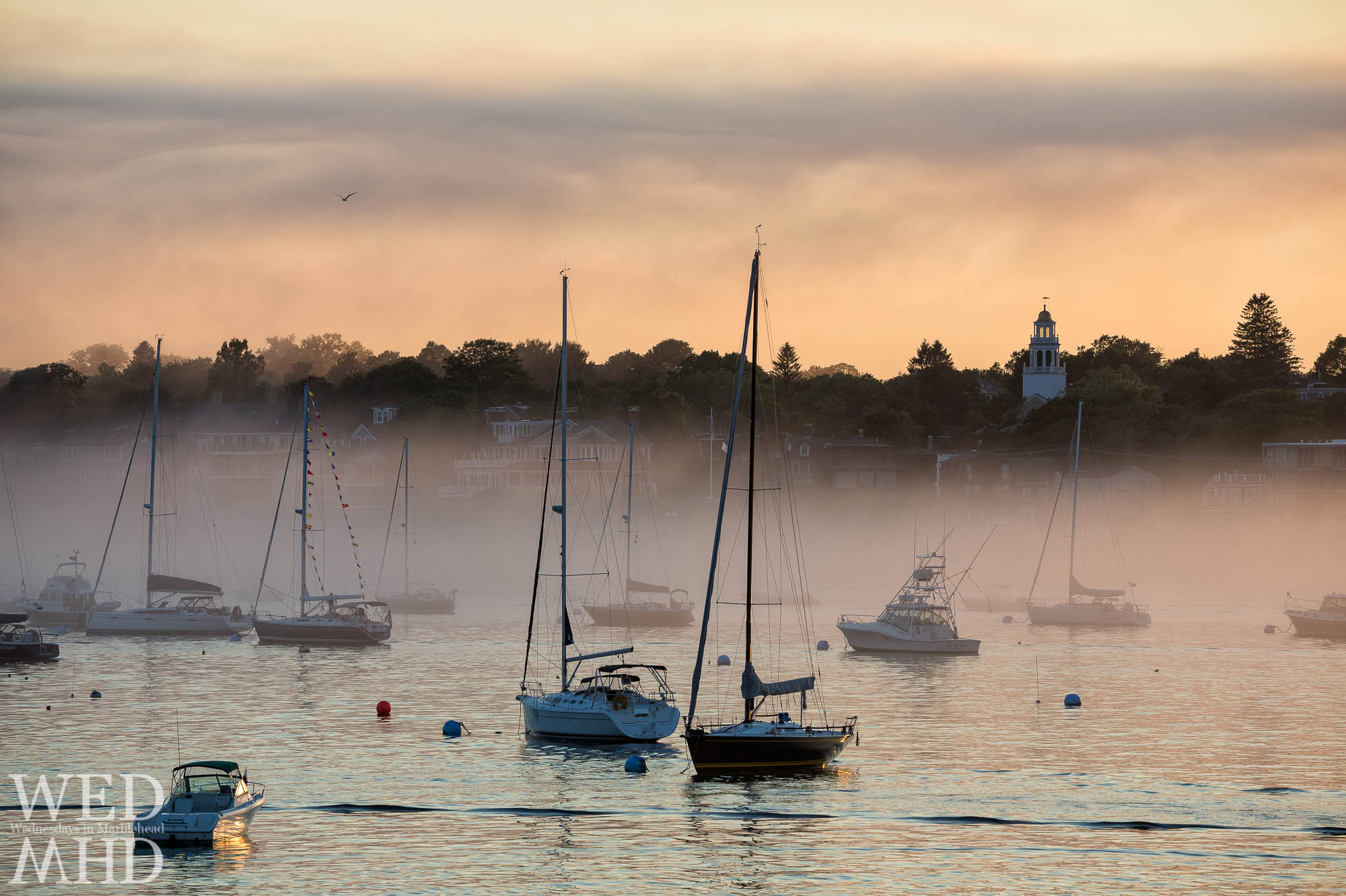 Remembering humid days and foggy nights in Marblehead Harbor with boats moored in front of Old North Church