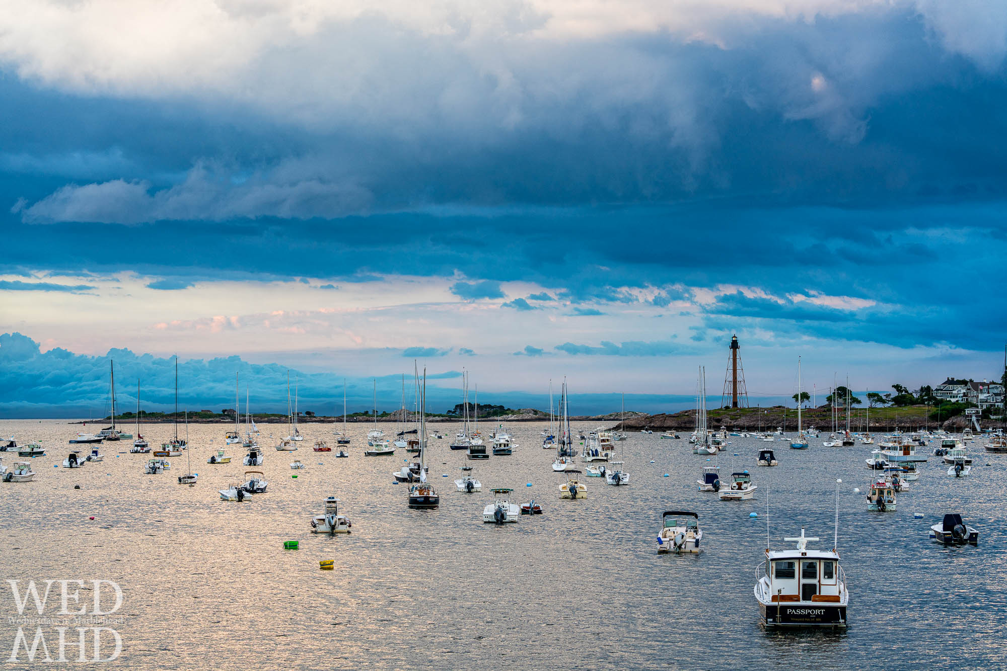 Blue clouds close to the horizon seem to be washing over Childrens Island as storms pass to the north of Marblehead