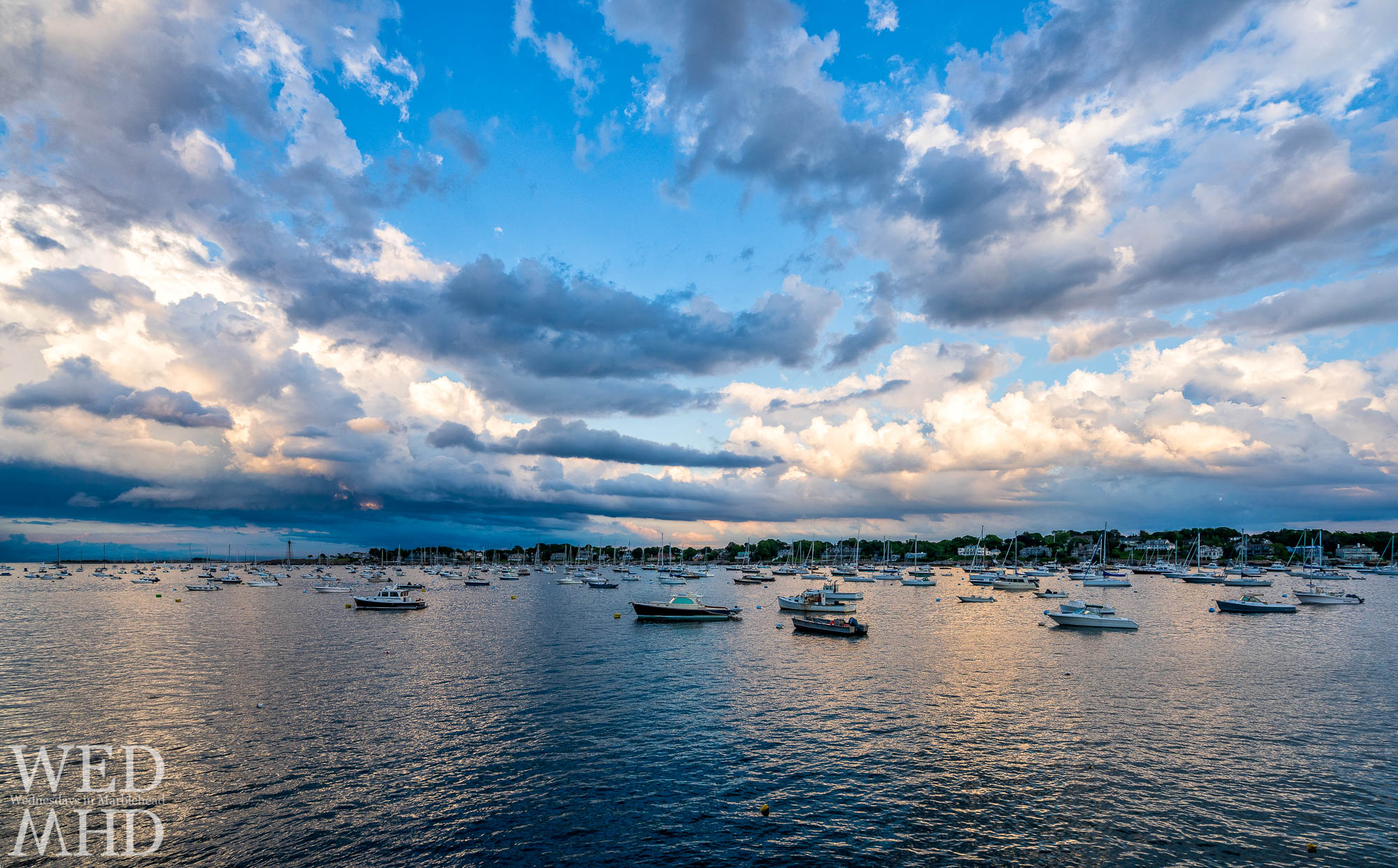 As a sunset takes shape over Marblehead Harbor, I swapped for my widest lens in the hopes of taking it all in