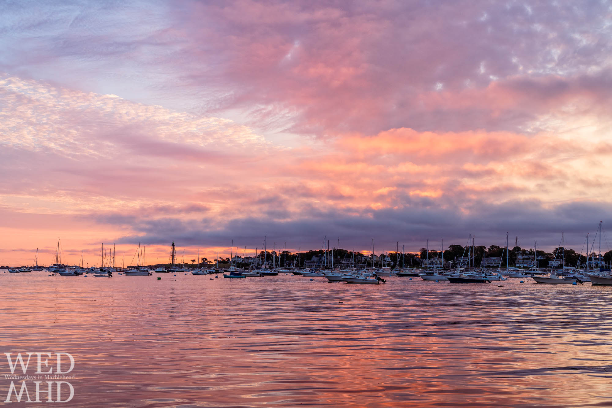 A gameday sunrise forms over Marblehead Harbor still filled with boats on this early October morning with a storm headed our way